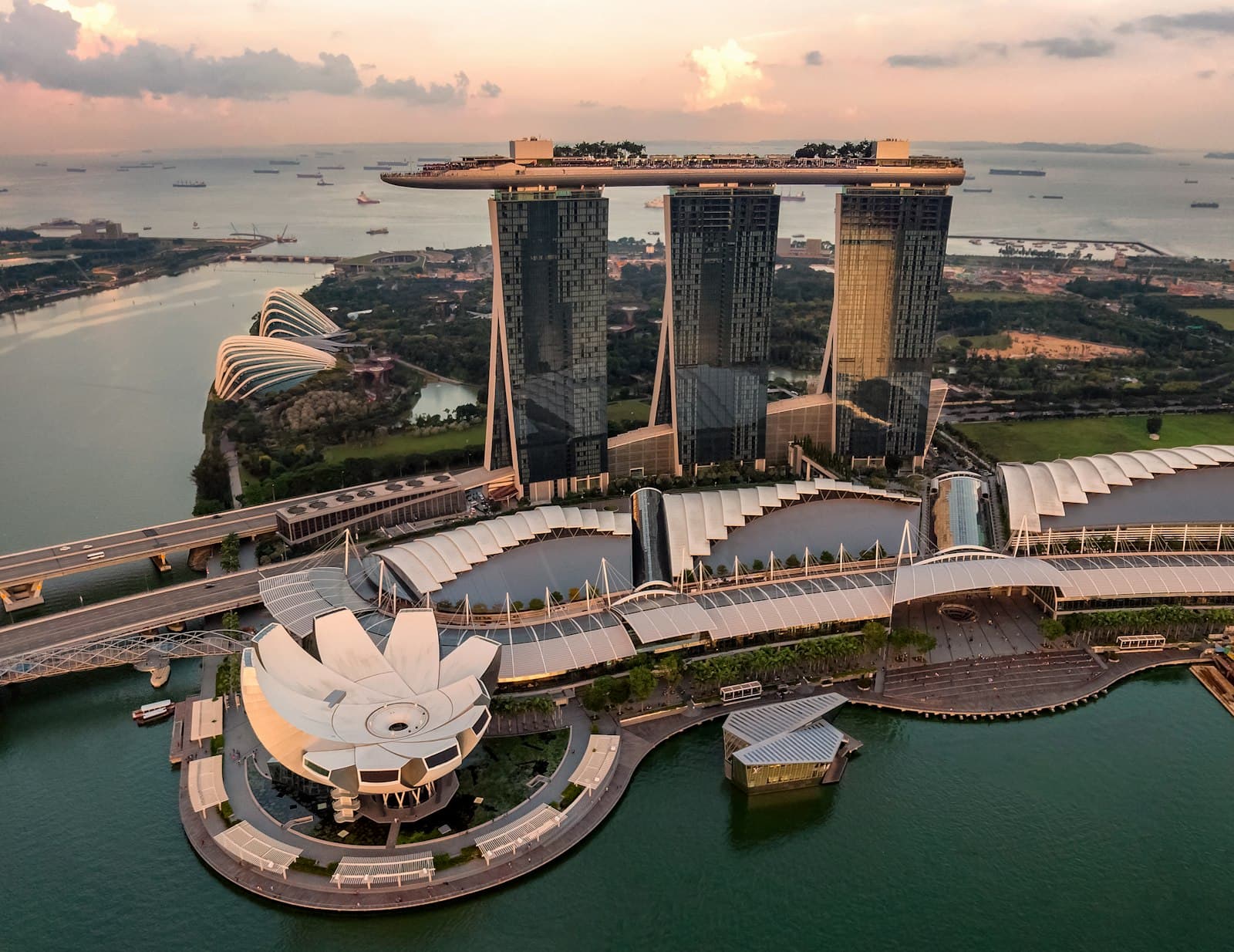 Marina Bay Sands, the ArtScience Museum and Gardens by the Bay seen from the air at dusk