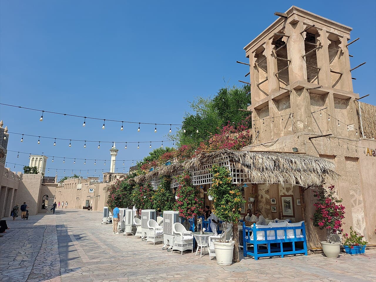 Restored wind-tower houses and a shaded courtyard cafe in the Al Fahidi historic district, Dubai