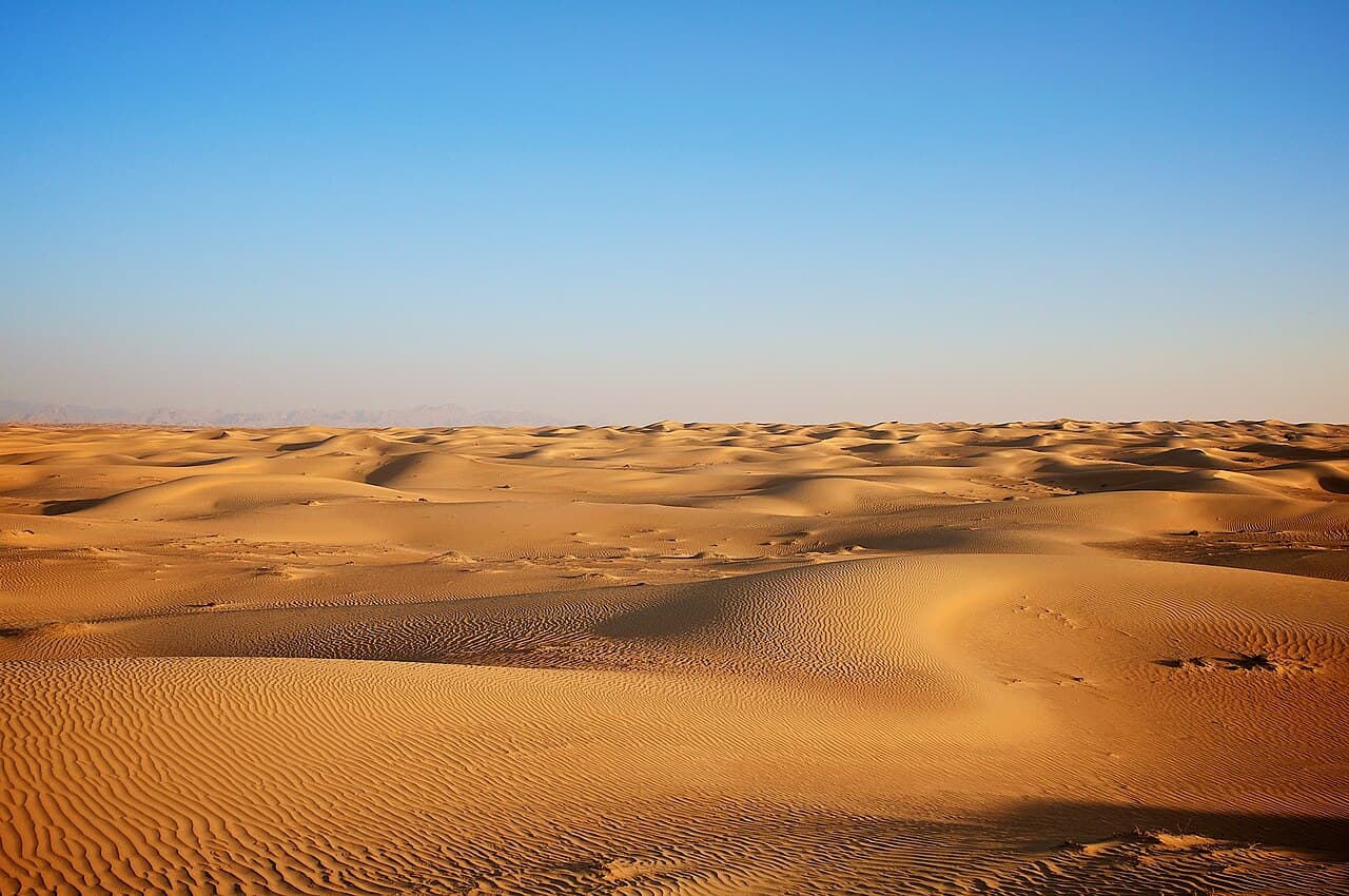 Rippled red sand dunes in the desert outside Dubai at golden hour