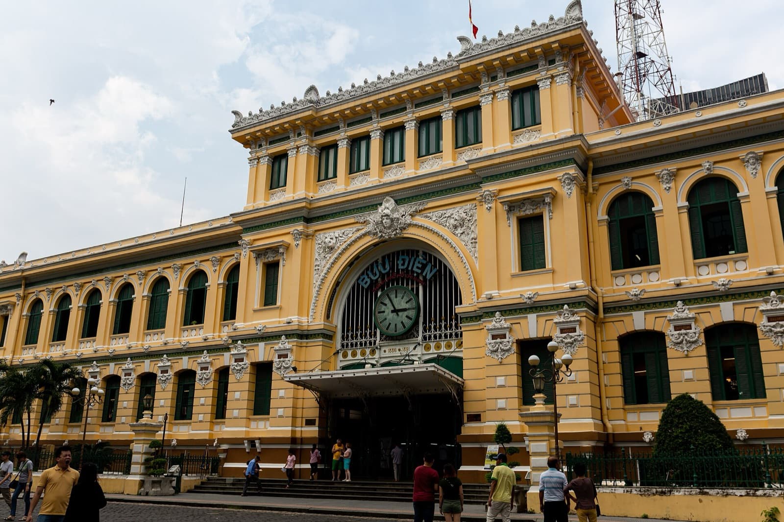 The yellow colonial facade and arched clock entrance of the Saigon Central Post Office in Ho Chi Minh City